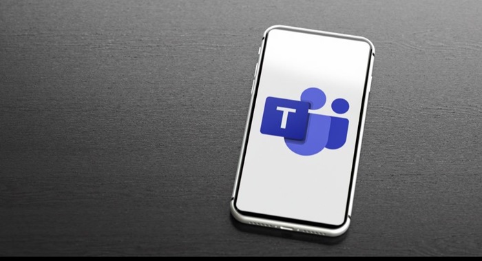 Image of a cell phone with the Microsoft Teams logo on the screen.