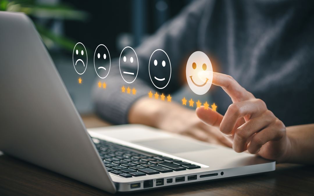 Image of a person selecting a happy face indicating a positive review