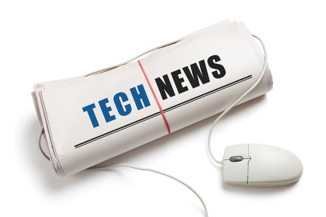 A newspaper with a mouse cable wrapped around it and IT News as the headline.