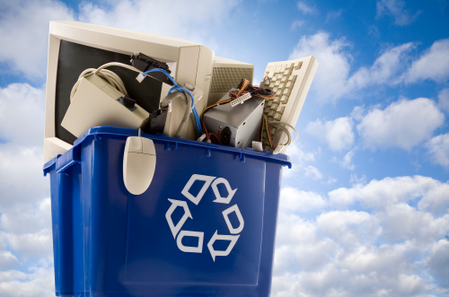 Image of blue recycle bin with computers in it.
