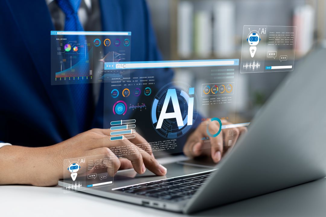 Image of a person on a laptop with AI graphics over their hands.