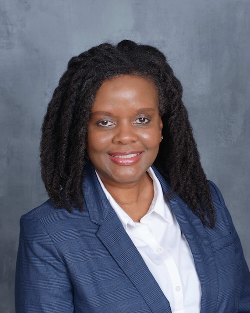 photo of woman in suit smiling for a headshot