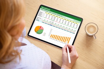 image of woman working on a spreadsheet on her ipad
