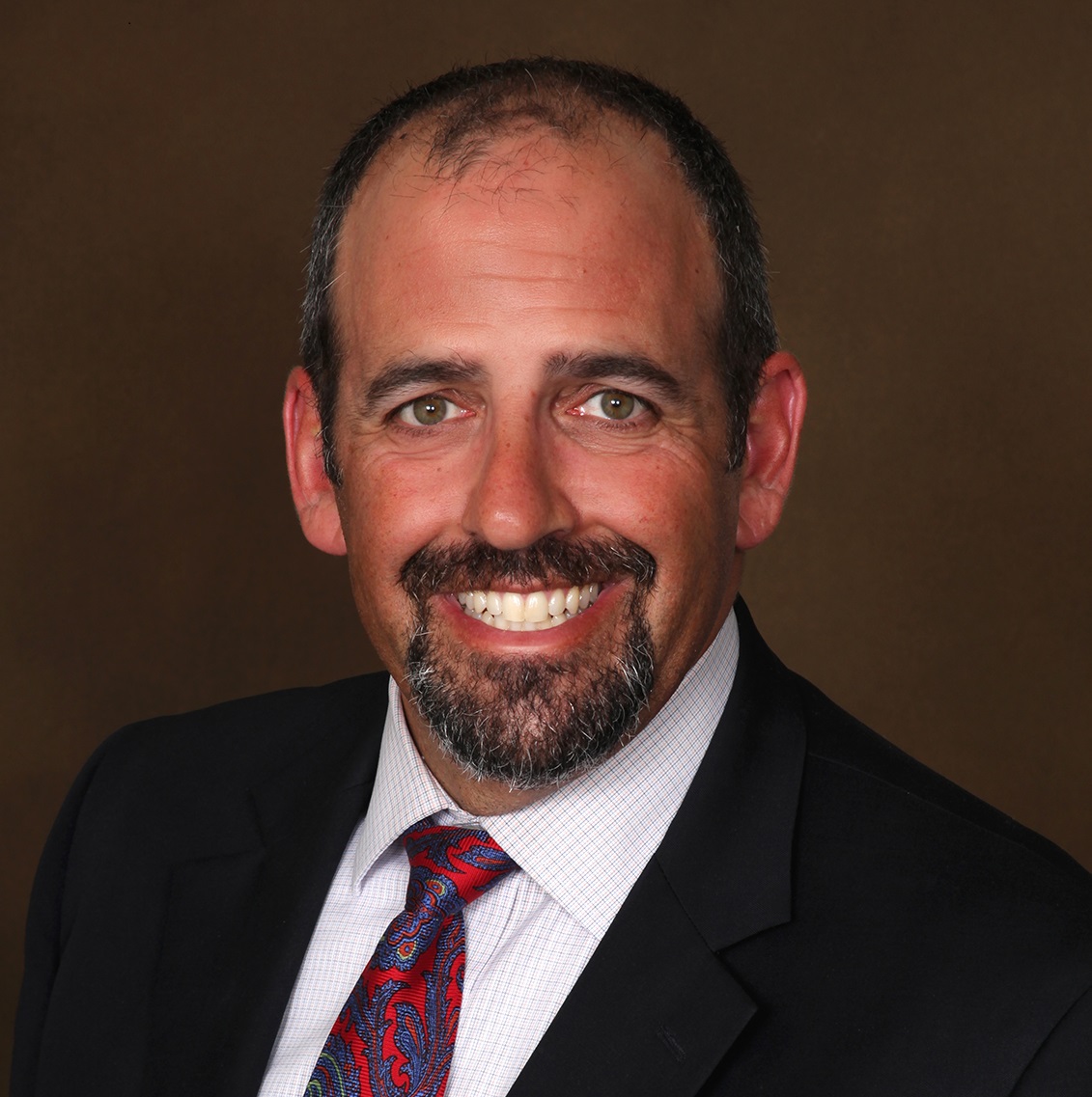 Image of man in suit smiling at camera