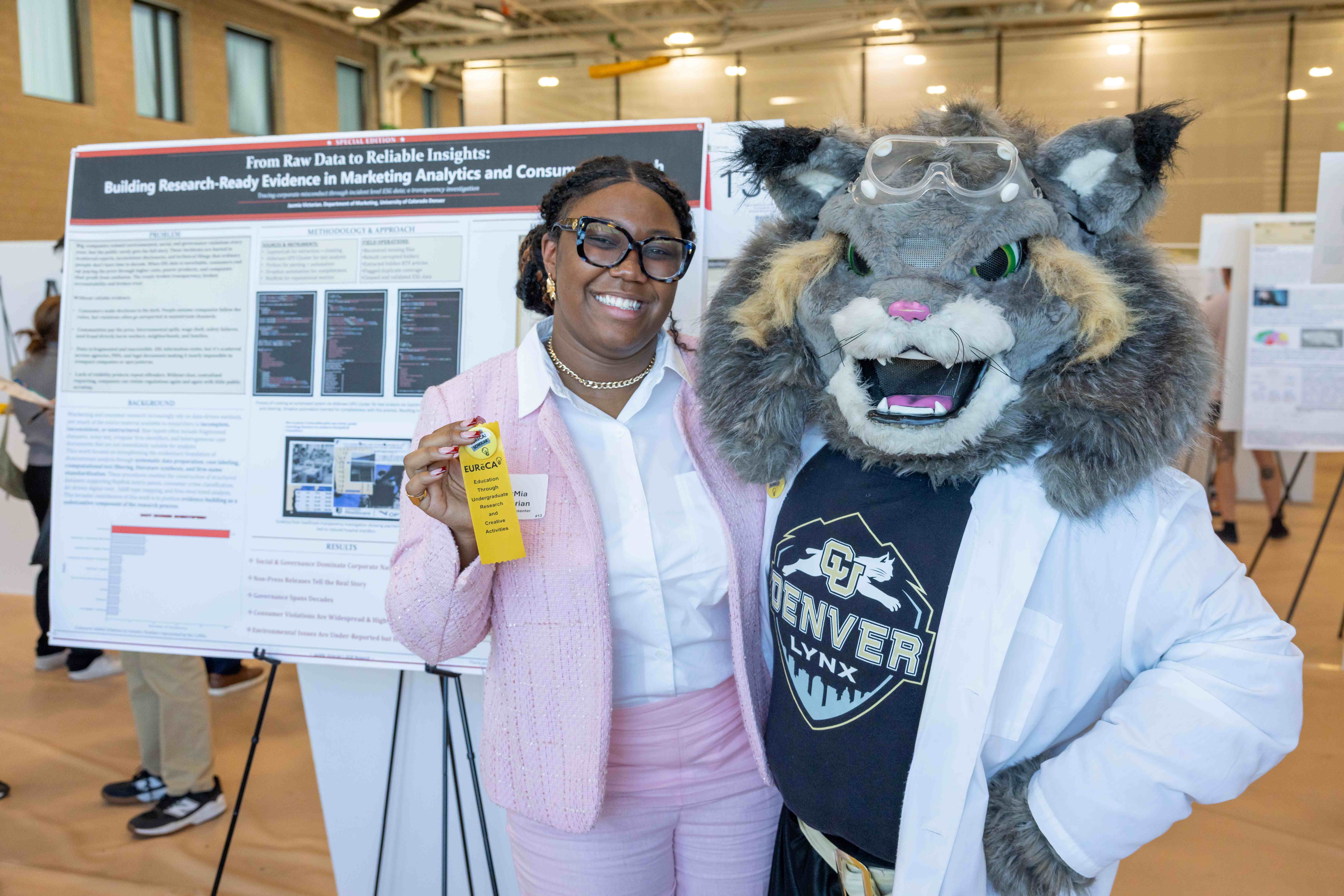 student with CU Denver Mascot, Milo