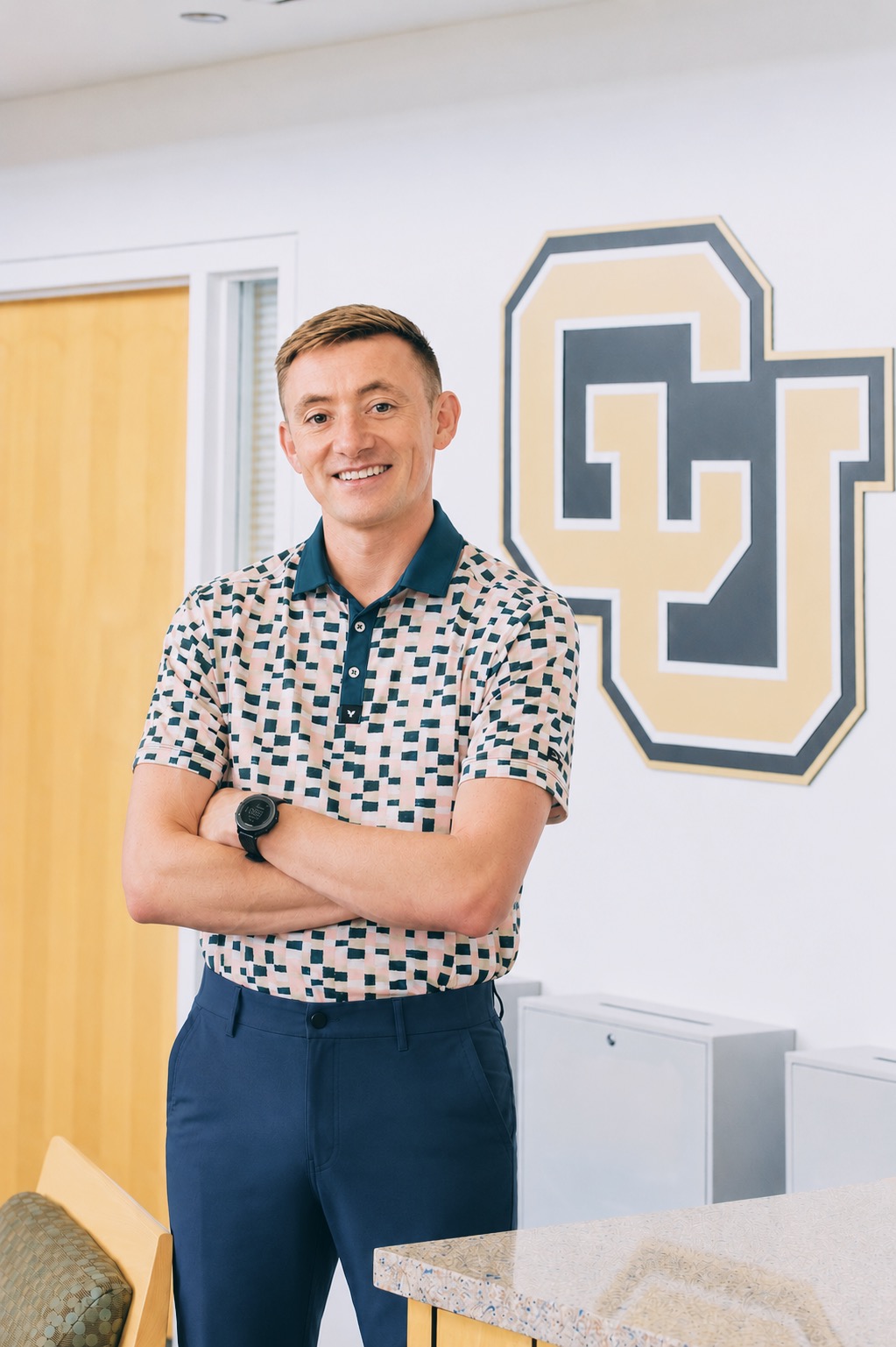Jake Lueders, Assistant Director - white, male, brown hair, blue plants, checkered polo