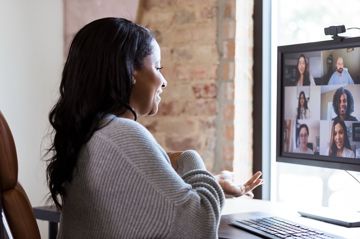 Woman participating in a virtual meeting on a computer