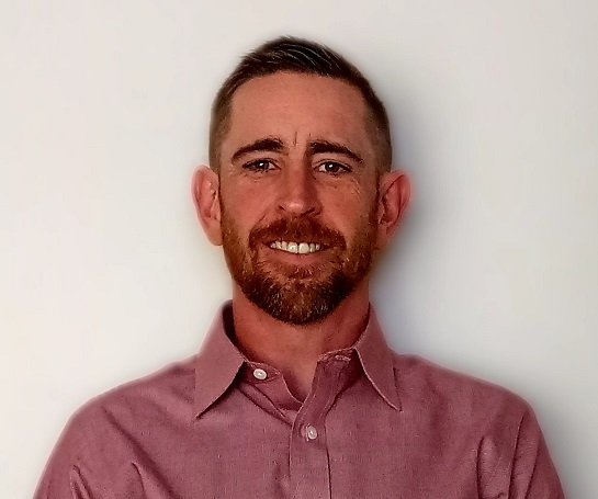 Picture of Dustin Foster, man wearing pink button down shirt