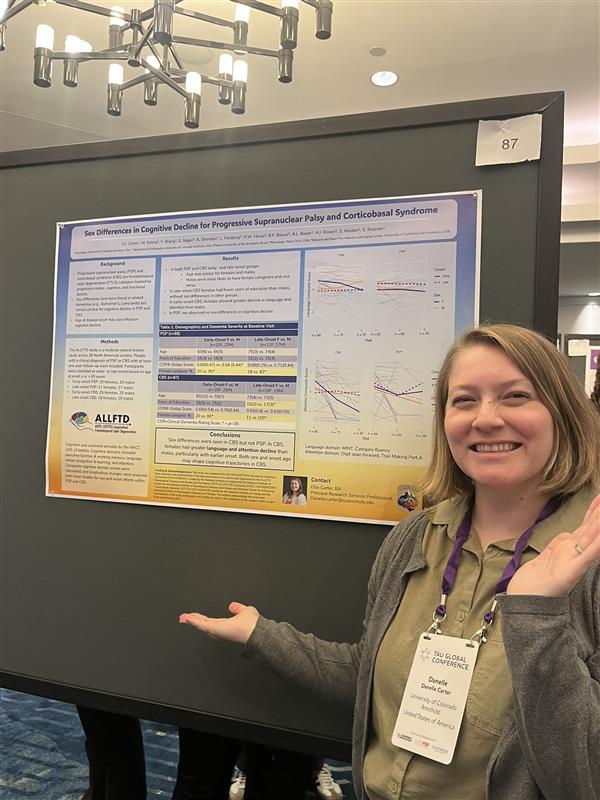 ElliepresentsaposterattheTauGlobalConference