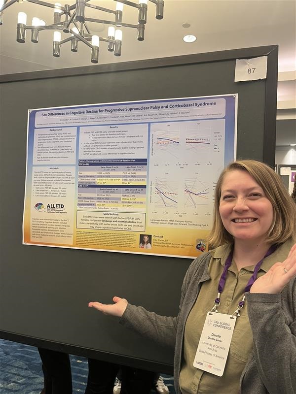 ElliepresentsaposterattheTauGlobalConference