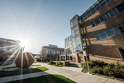 sun peaking over campus
