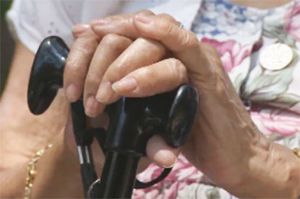 woman's hands on cane