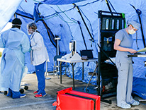 health workers in a tent