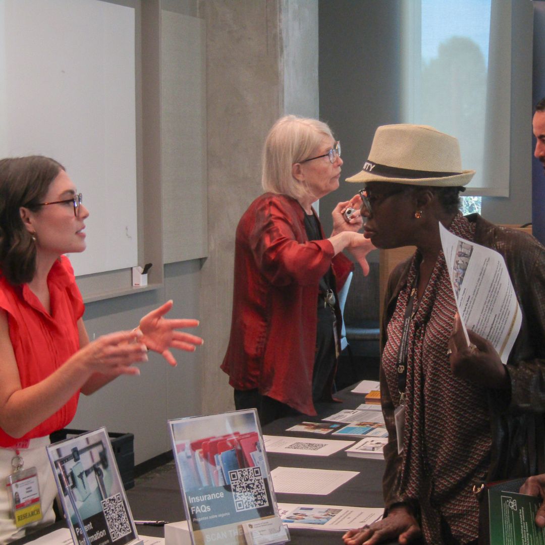 Researcher talking with an attendee at a Research Roadshow.