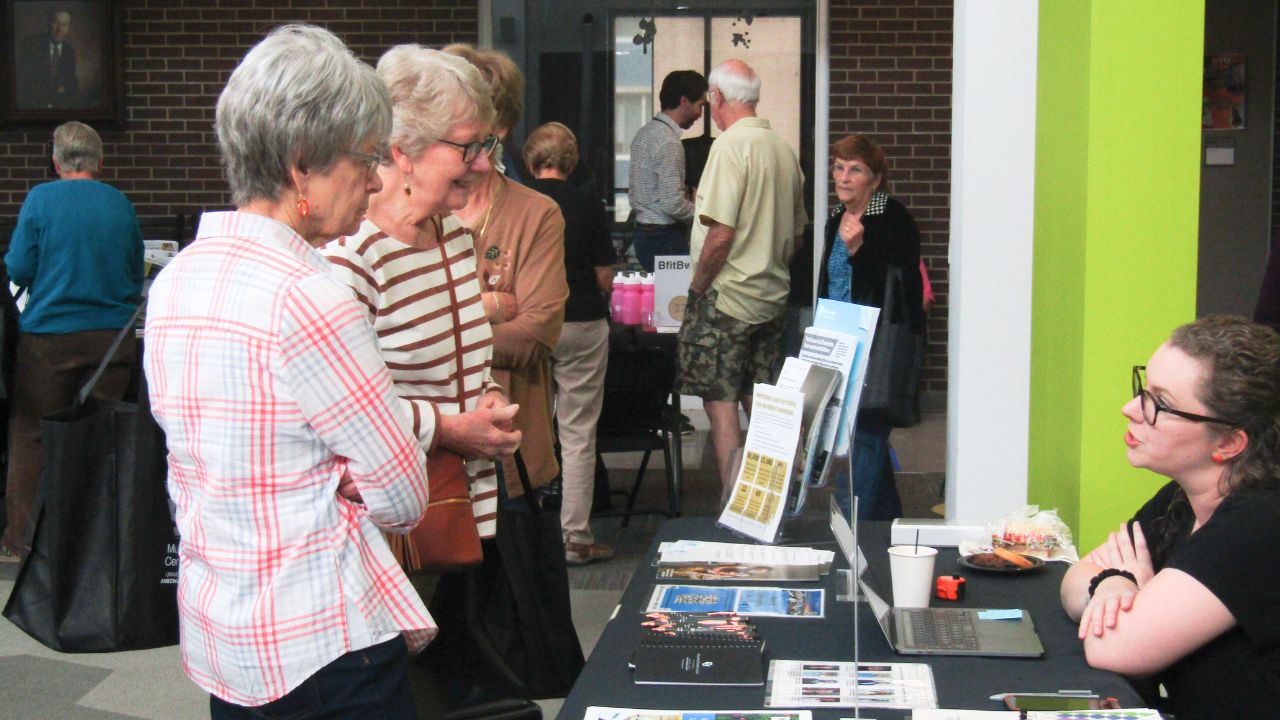 Image of attendee and researcher talking at a Research Roadshow.