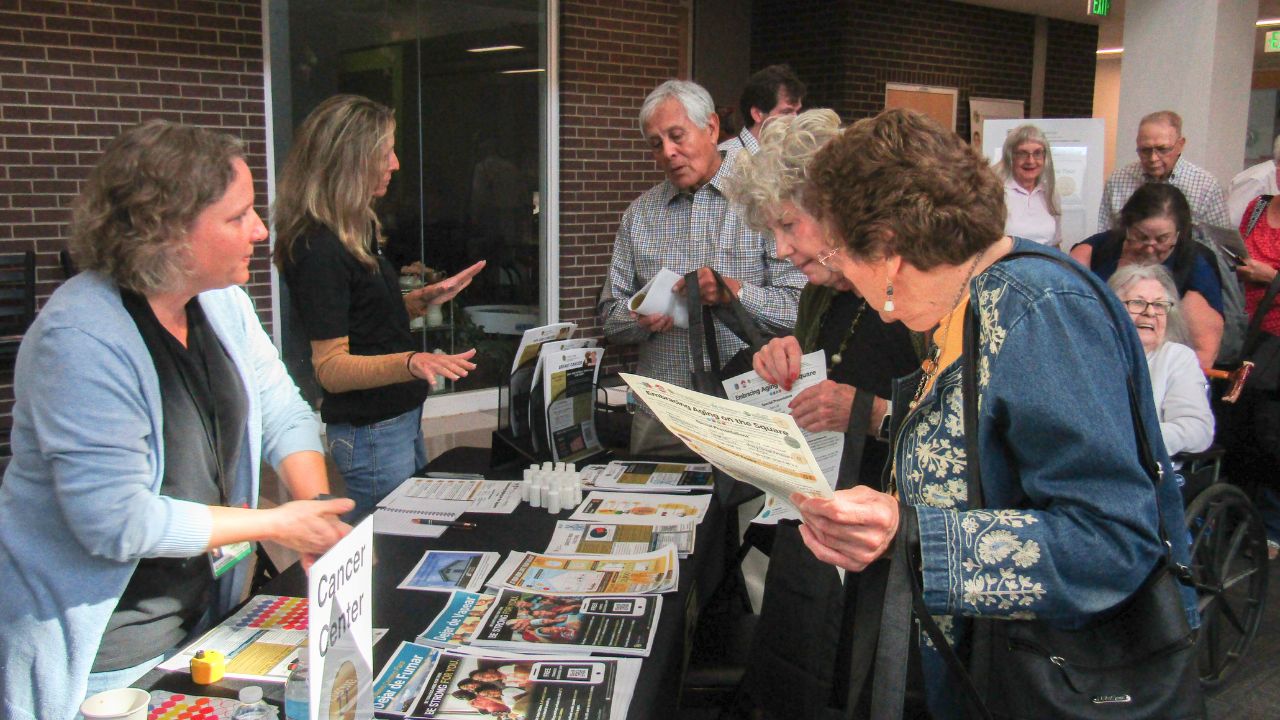 Attendees and researchers talking at a Research Roadshow.