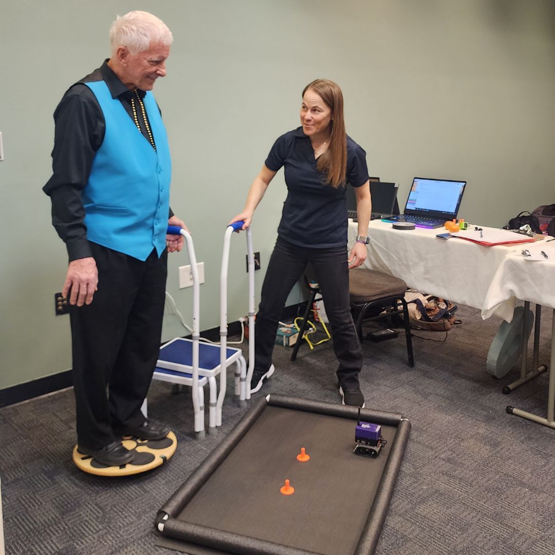 Attendee trying out a balance board activity at the Chaffee County Research Roadshow.