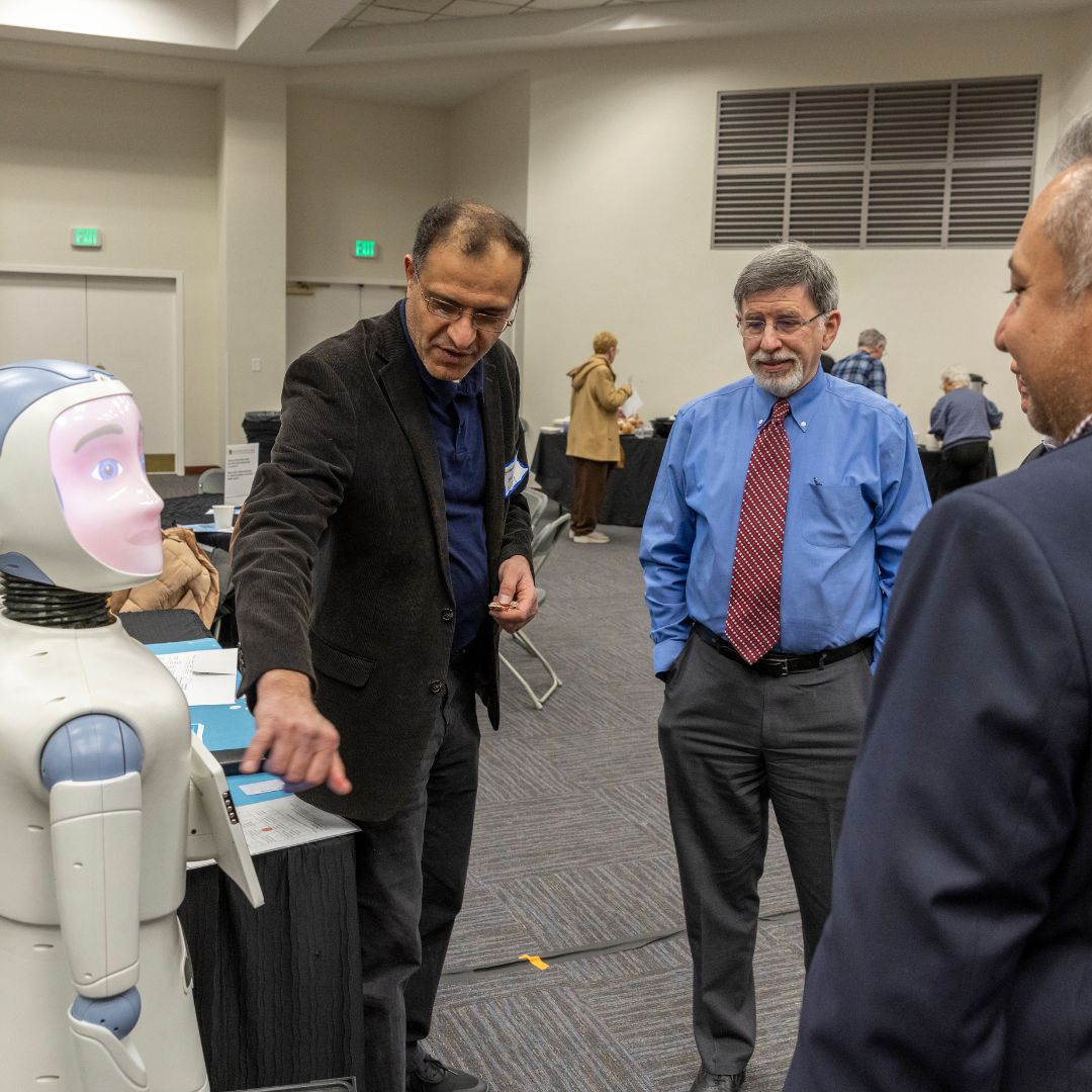Attendees interacting with Ryan the Robot.