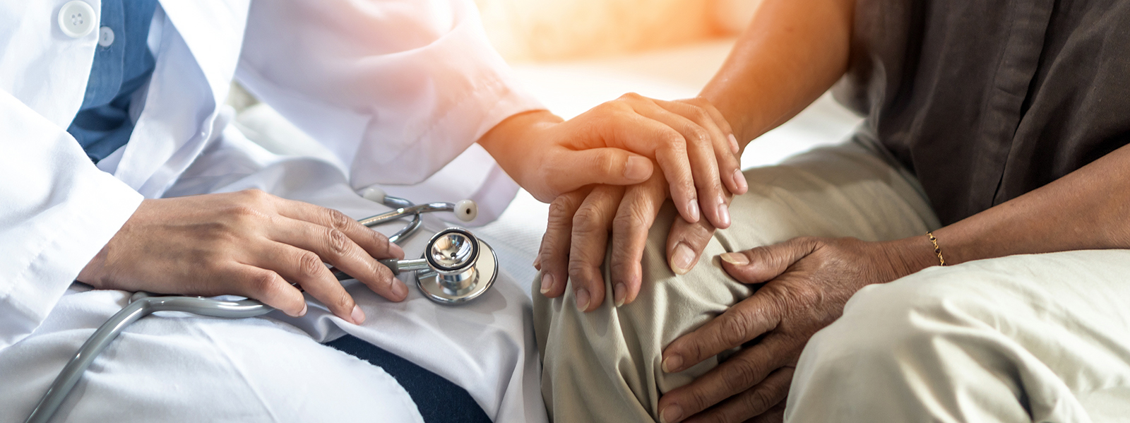 Doctor holding patient's hand