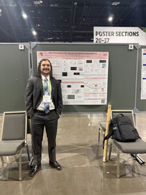Morgan Fox stands in front of his poster