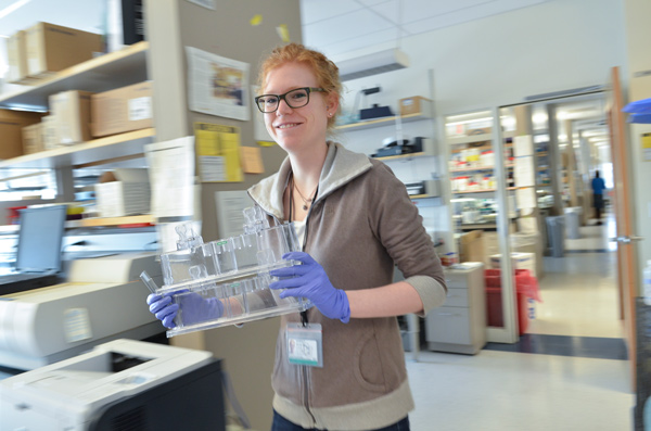 Scientist walking carrying test tubes Scientist walking carrying test tubes
