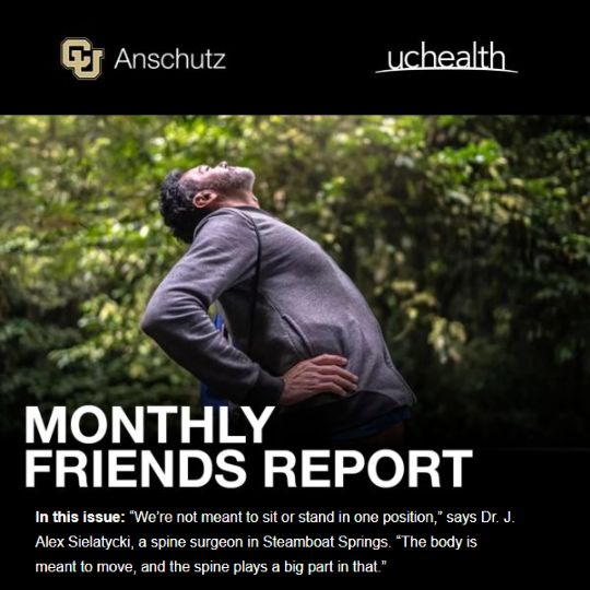 Monthly Friends Report: A man does a backward back-bend outdoors in a lush, green forest.
