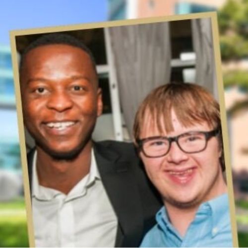 A doctor and patient with down syndrome pose happily for a picture together.