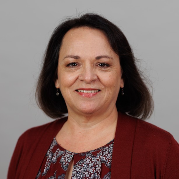 Professional headshot of Dr. Deborah Parra-Medina, who is smiling at the camera