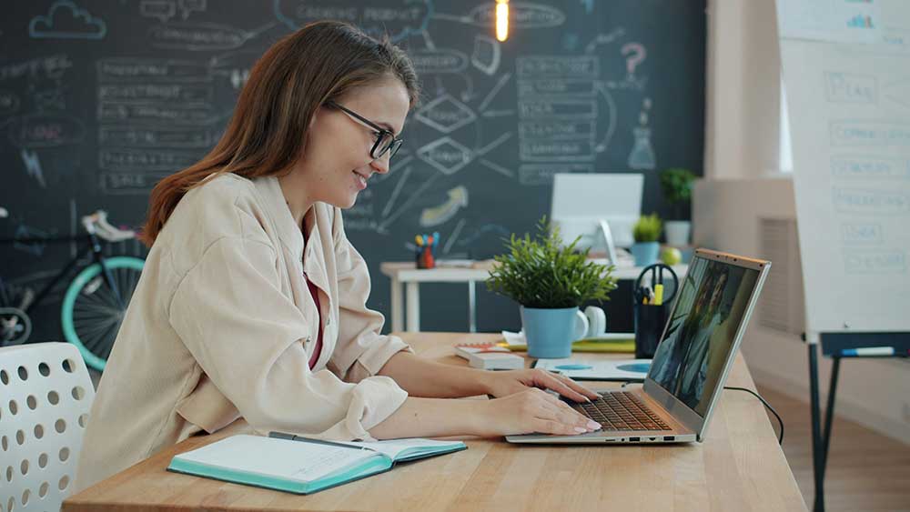 woman working at laptop in classroom
