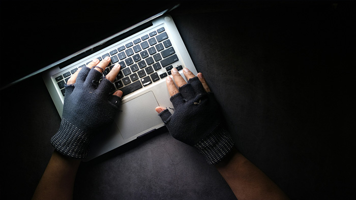 criminal hands on a laptop