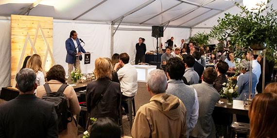 crowd in a tent with speaker