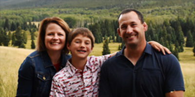 family with mountain backdrop