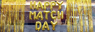 match day spelled with gold balloons