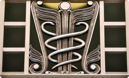 Art Deco medicine icon including snakes