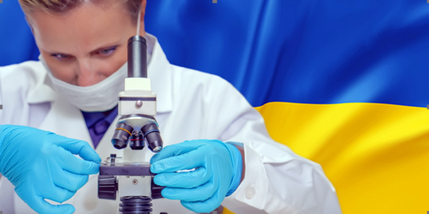 researcher at microscope