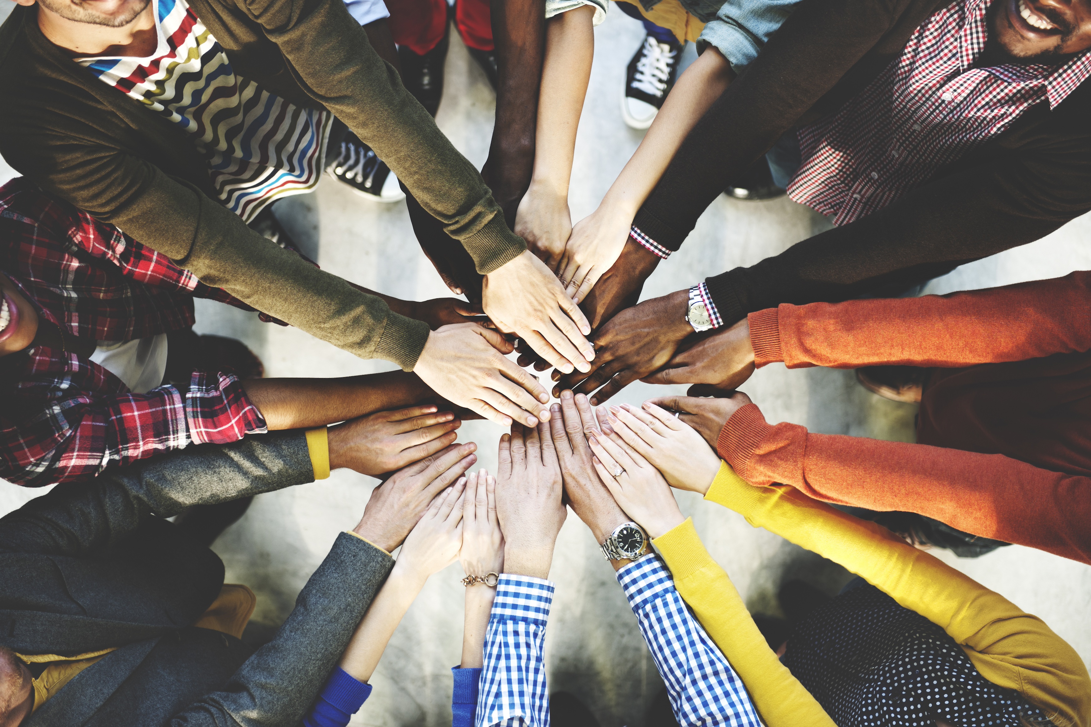 several hands in a circle