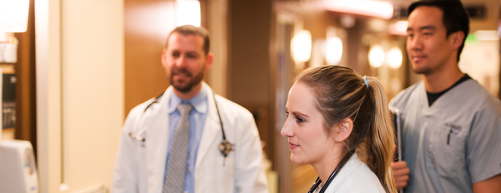 three students on clinical rotation in hallway at uch