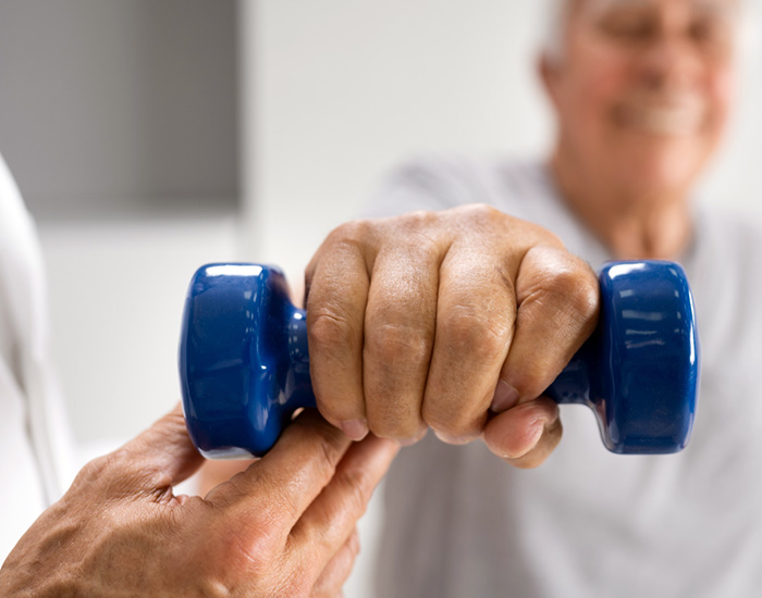 handweight held by elderly man