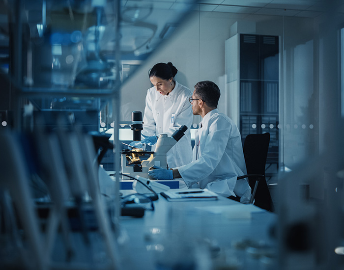 two people talking in blue lab