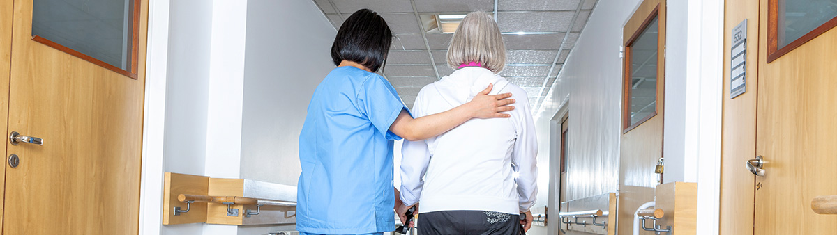woman with helper in hallway