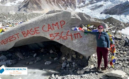 Donna Lynne next to boulder with writing