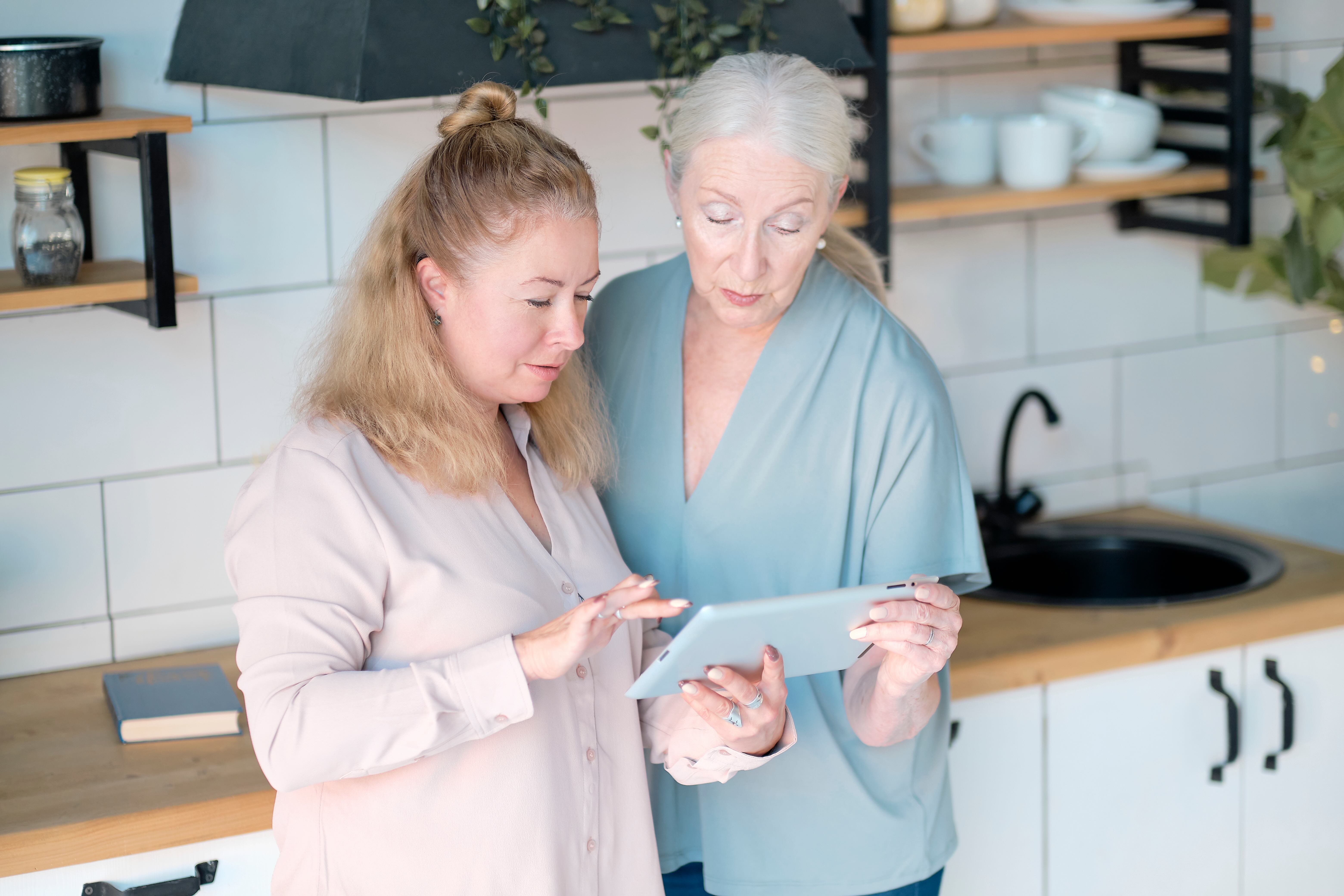 A tech mentor supports an older adult