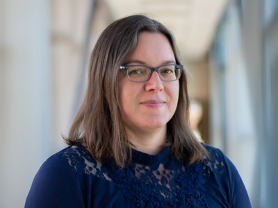 Woman in blue shirt and glasses
