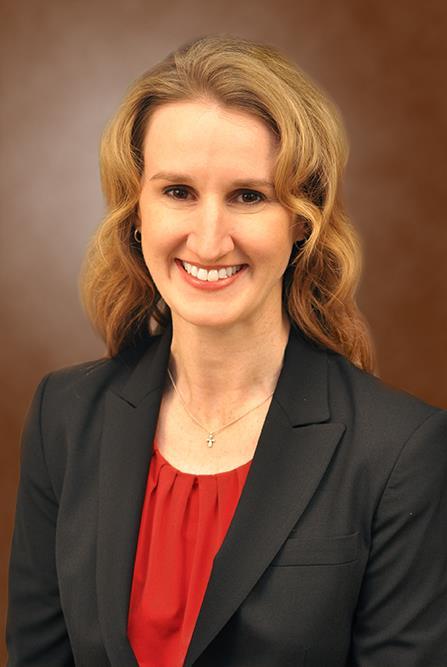 blonde woman in red shirt and black blazer