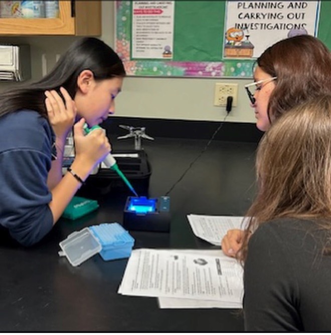 two high schoolers doing a science experiment