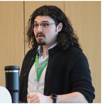 Man with long curly hair presenting