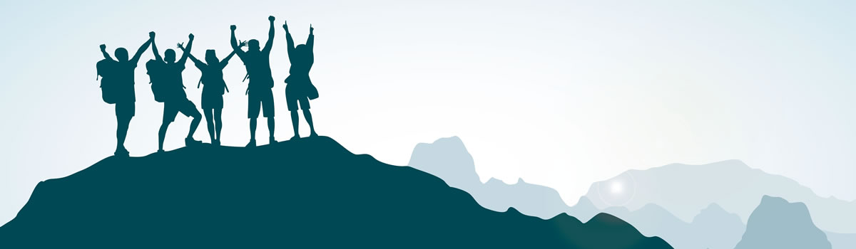 Hikers standing triumphantly on a mountaintop