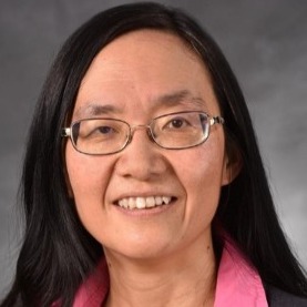 Yiqun Shellman, PhD, professional picture wearing a pink shirt, grey blazer, and glasses