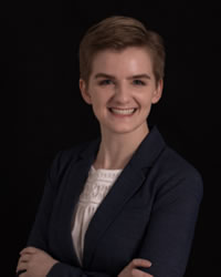 Anna Tappel smiling and wearing a black blazer
