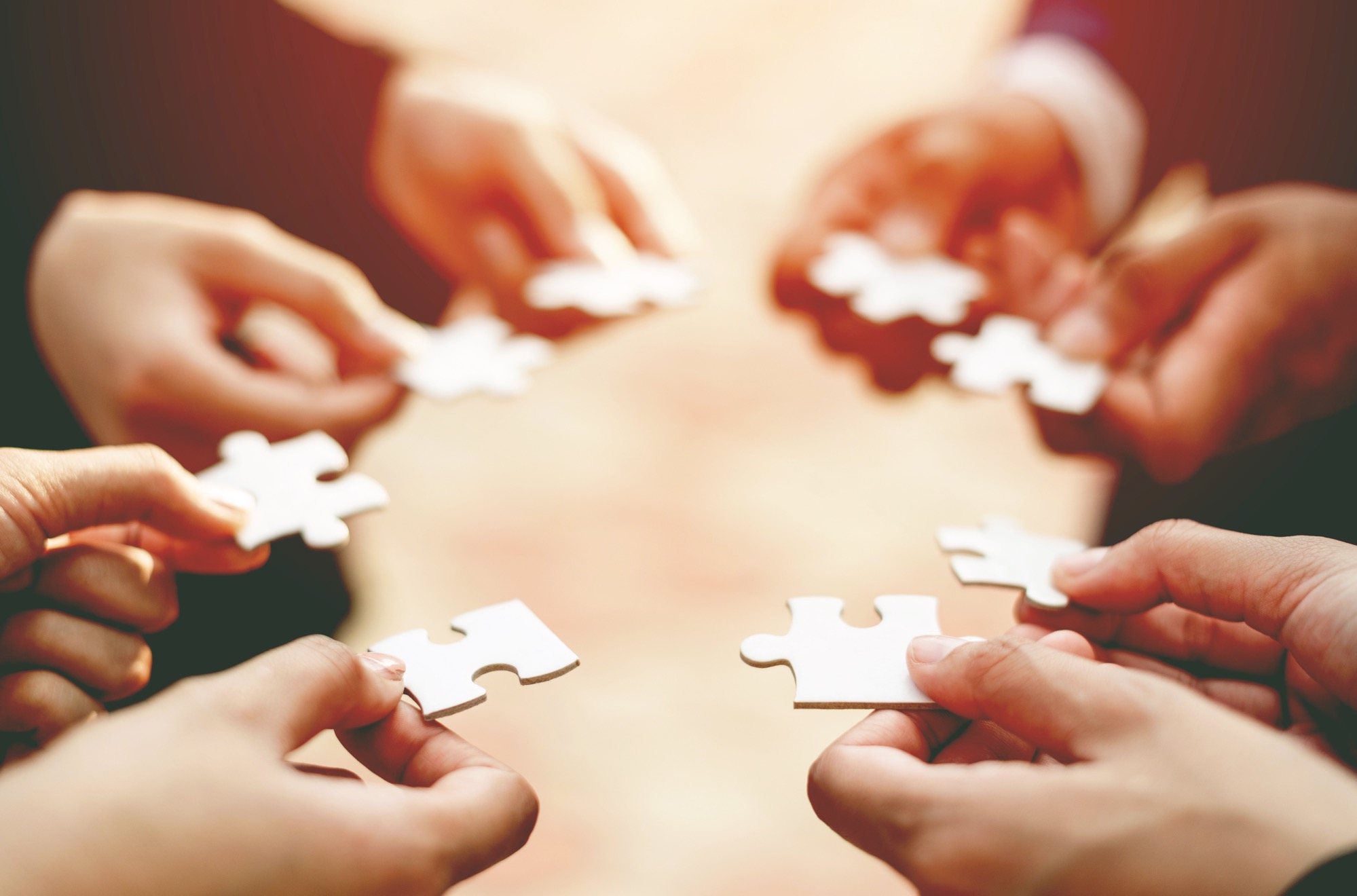 Picture of people holding puzzle pieces